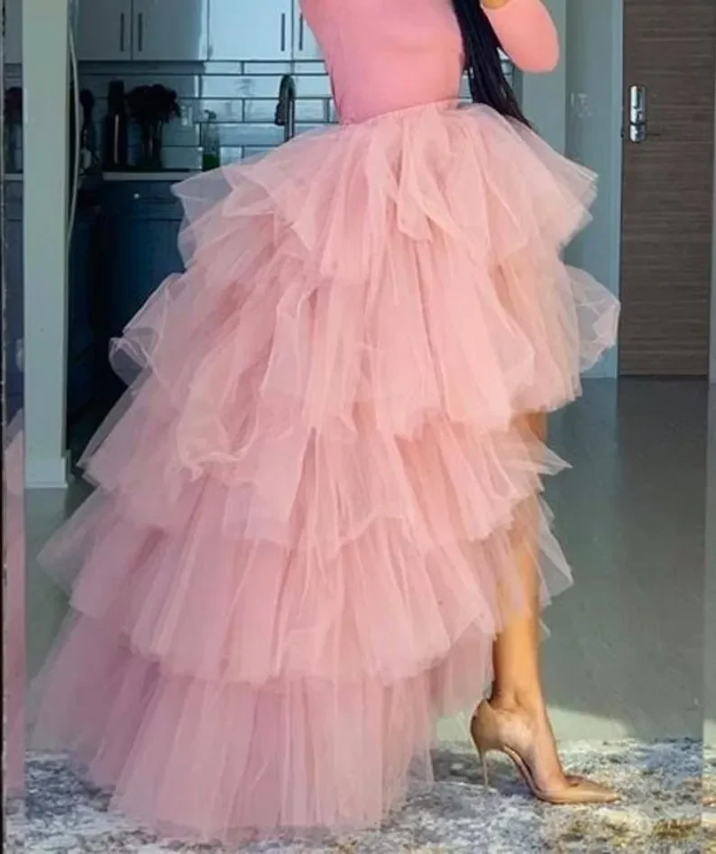 Women's asymmetric pink tulle skirt with tiered ruffles styled for a party